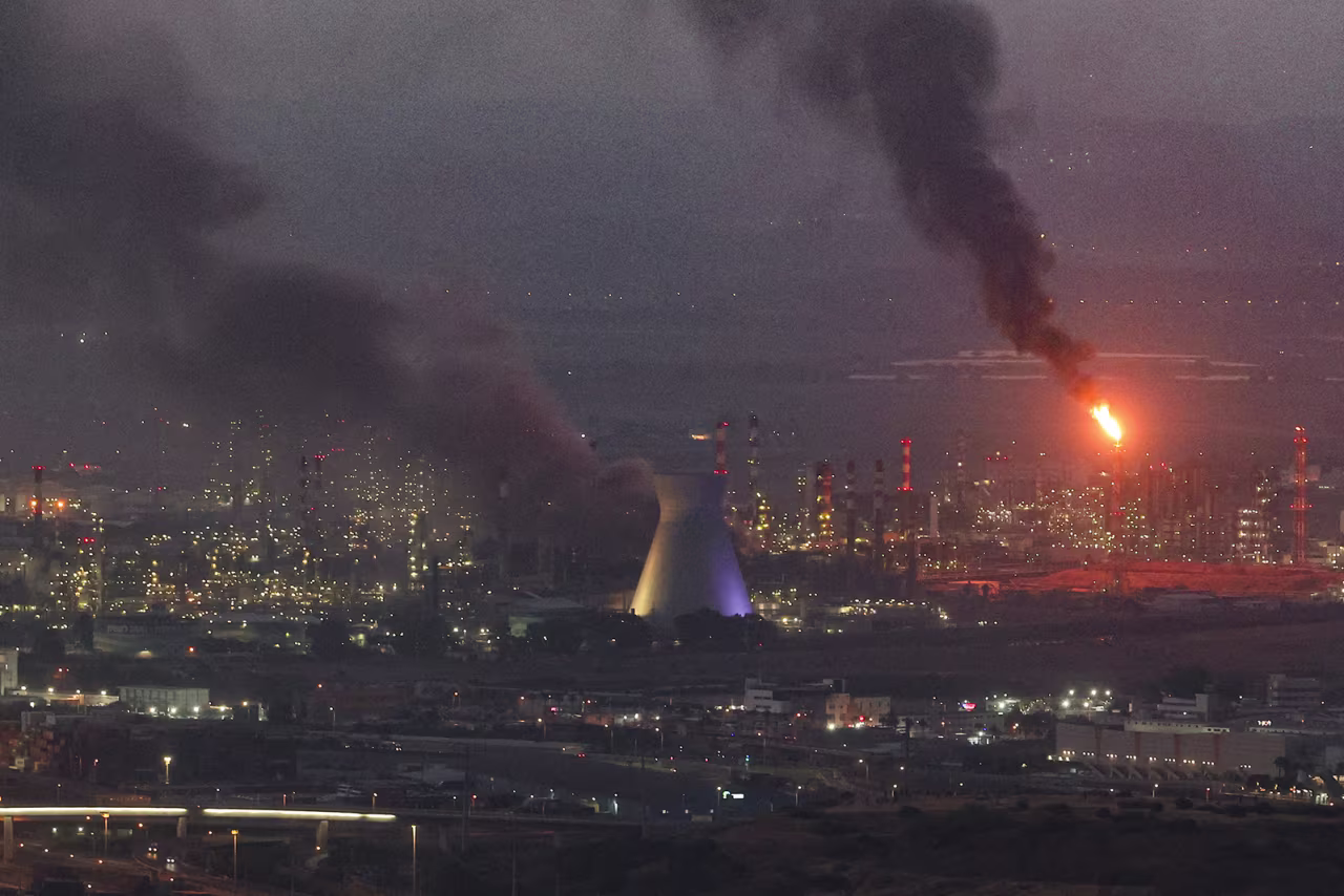 Smoke billows from a site in the city of Haifa on Monday.
