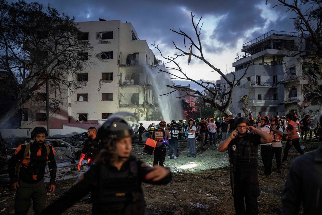 Israeli security personnel and first responders inspect an area hit by an Iranian missile strike on central Tel Aviv on Monday.