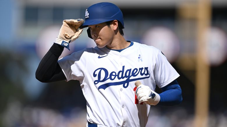 LOS ANGELES, CA - JUNE 15: Shohei Ohtani #17 of the Los Angeles Dodgers greets the third base umpire in the first inning against the San Francisco Giants during a regular season MLB game on June 15, 2025, at at Dodger Stadium in Los Angeles. CA. (Photo by John McCoy/Icon Sportswire via Getty Images)