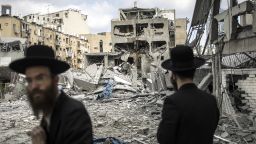 Ultra-Orthodox Jewish men inspect the damage at the site of an Iranian missile strike in Bnei Brak, east of Tel Aviv, on June 16, 2025. Iran unleashed a barrage of missile strikes on Israeli cities early on June 16, after Israel struck military targets deep inside Iran, with both sides threatening further devastation. (Photo by JOHN WESSELS / AFP) (Photo by JOHN WESSELS/AFP via Getty Images)          