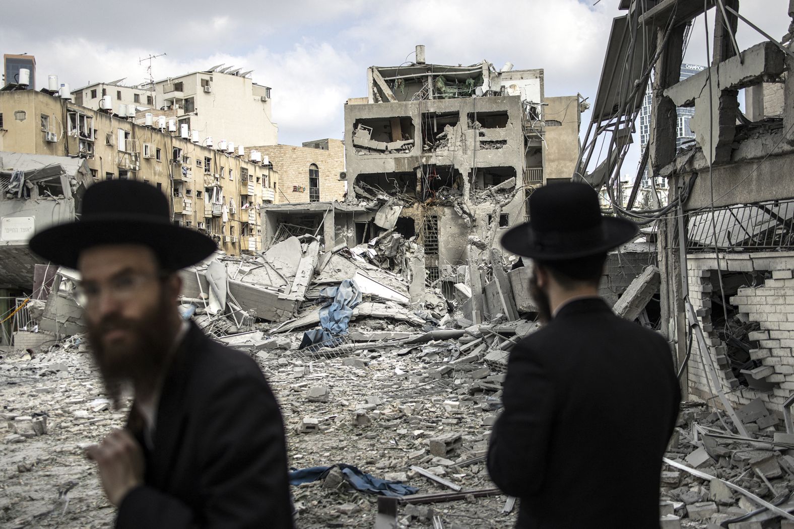 Ultra-Orthodox Jewish men inspect the damage at the site of an Iranian missile strike in Bnei Brak, Israel.