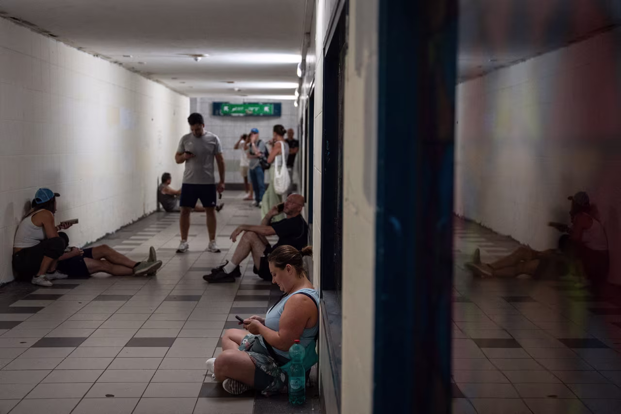 Israelis take shelter during a missile siren alert in Haifa.