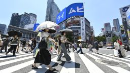 People cross the iconic Shibuya crossroad on June 17, 2025, in Tokyo, Japan.