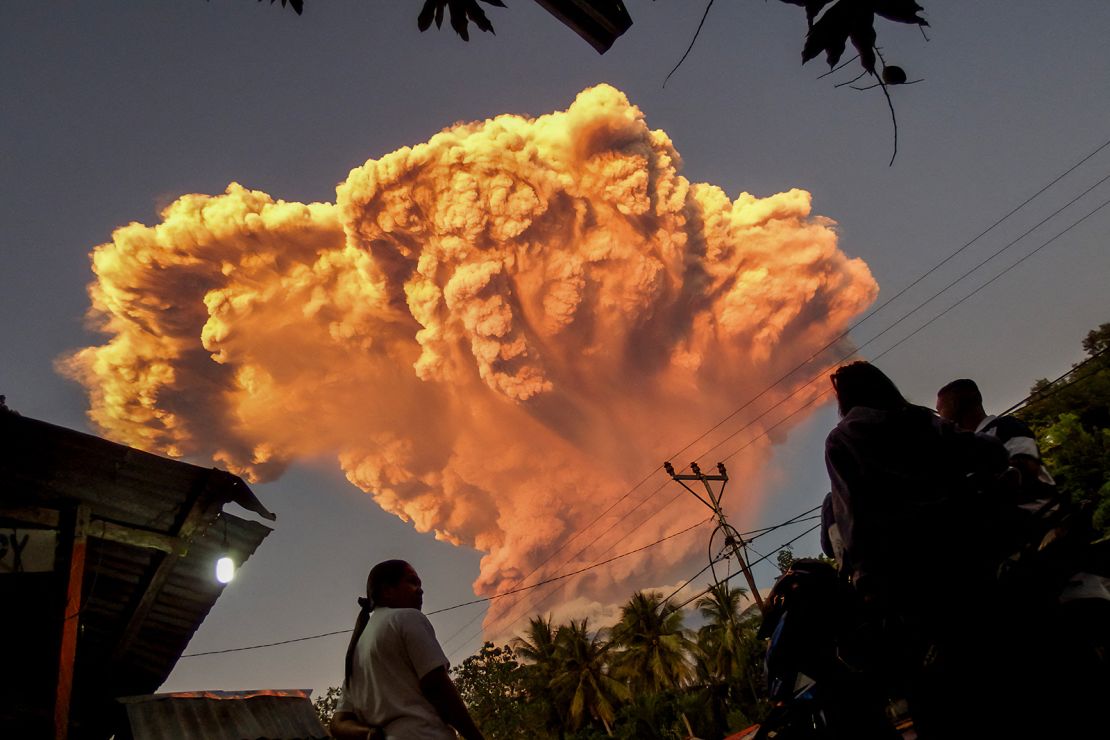 An orange mushroom-shaped cloud dispersed above the village of Talibura in the eruption which could be seen up to 93 miles (150km) away.