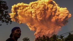 A villager watches the eruption of Mount Lewotobi Laki-Laki as seen from Talibura village in Sikka, East Nusa Tenggara, on June 17, 2025.