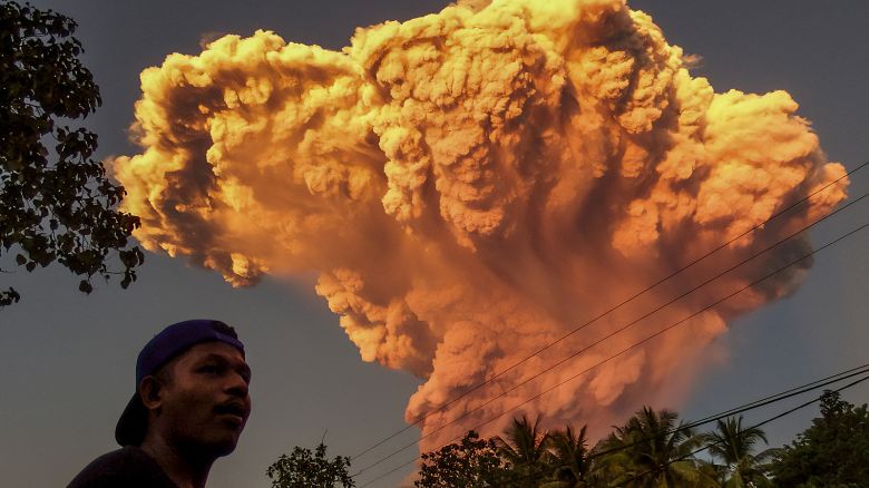 A villager watches the eruption of Mount Lewotobi Laki-Laki as seen from Talibura village in Sikka, East Nusa Tenggara, on June 17, 2025.