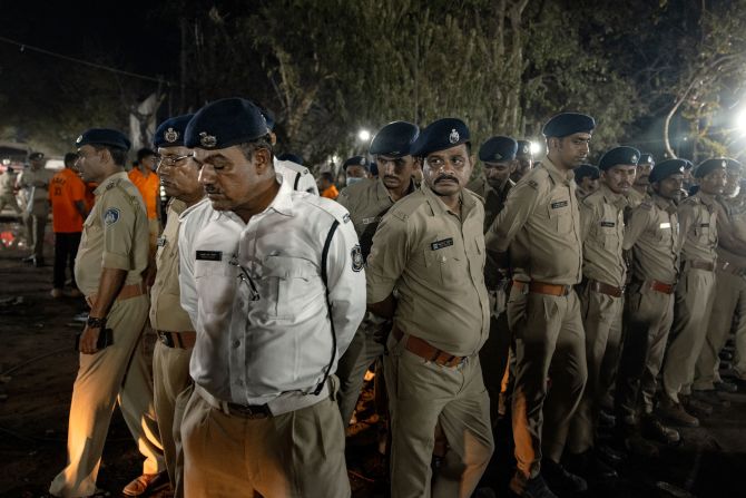 Security guards stand at the crash site.