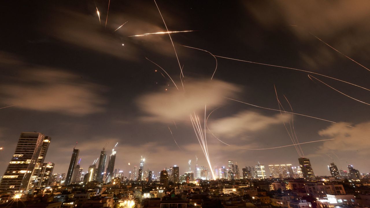 TOPSHOT - Israeli air defence systems are activated to intercept Iranian missiles over the Israeli city of Tel Aviv early on June 18, 2025. Israel and Iran exchanged fire again on June 17, the fifth day of strikes in their most intense confrontation in history, fuelling fears of a drawn-out conflict that could engulf the Middle East. (Photo by Menahem Kahana / AFP) (Photo by MENAHEM KAHANA/AFP via Getty Images)          