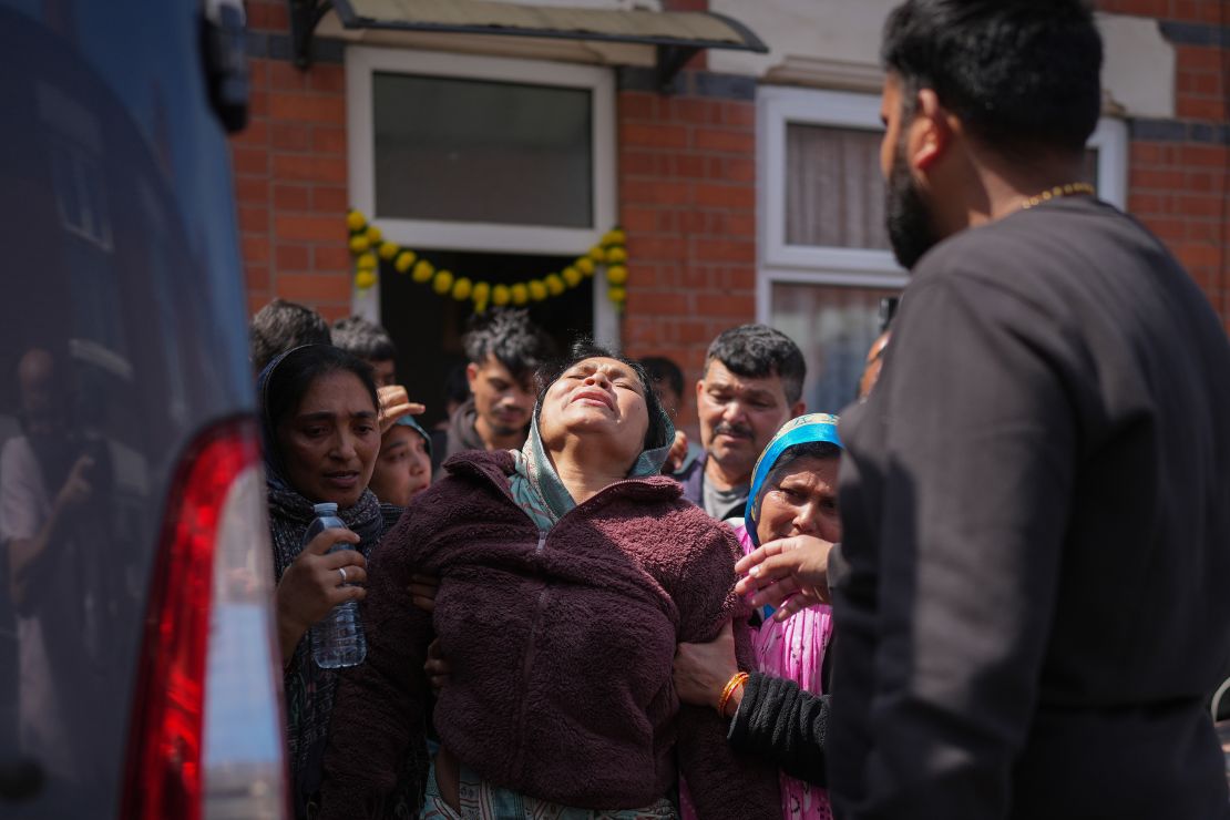 The mother of Vishwash Kumar Ramesh, the sole survivor of the Air India plane crash and his brother Ajay Ramesh, who died in the crash, boards a bus to travel to India on June 13, 2025 in Leicester, United Kingdom.