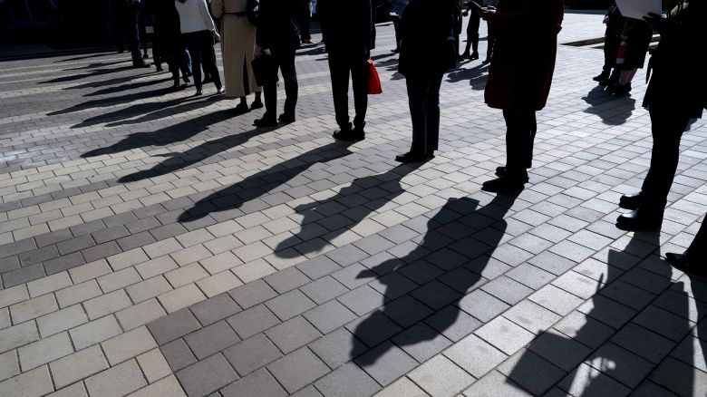 Job seekers wait in line to enter a job fair event in Silver Spring, Maryland, on April 16.