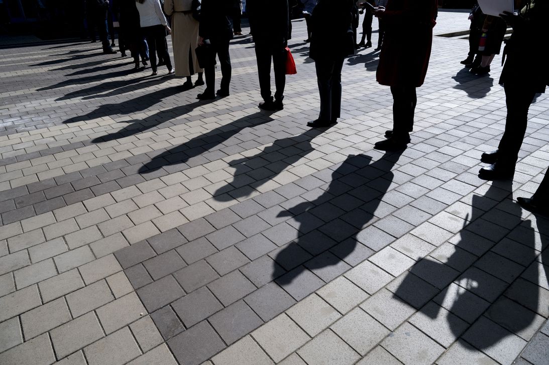 Job seekers wait in line to enter a job fair event in Silver Spring, Maryland, on April 16, 2025.