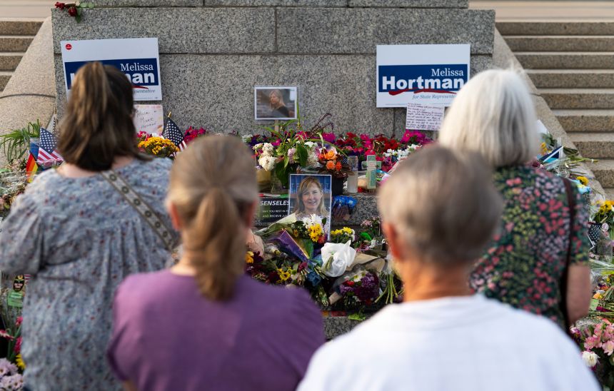 People look on at a memorial for Melissa and Mark Hortman during a candlelight vigil outside the state Capitol building in St. Paul, Minnesota, on June 18, 2025.