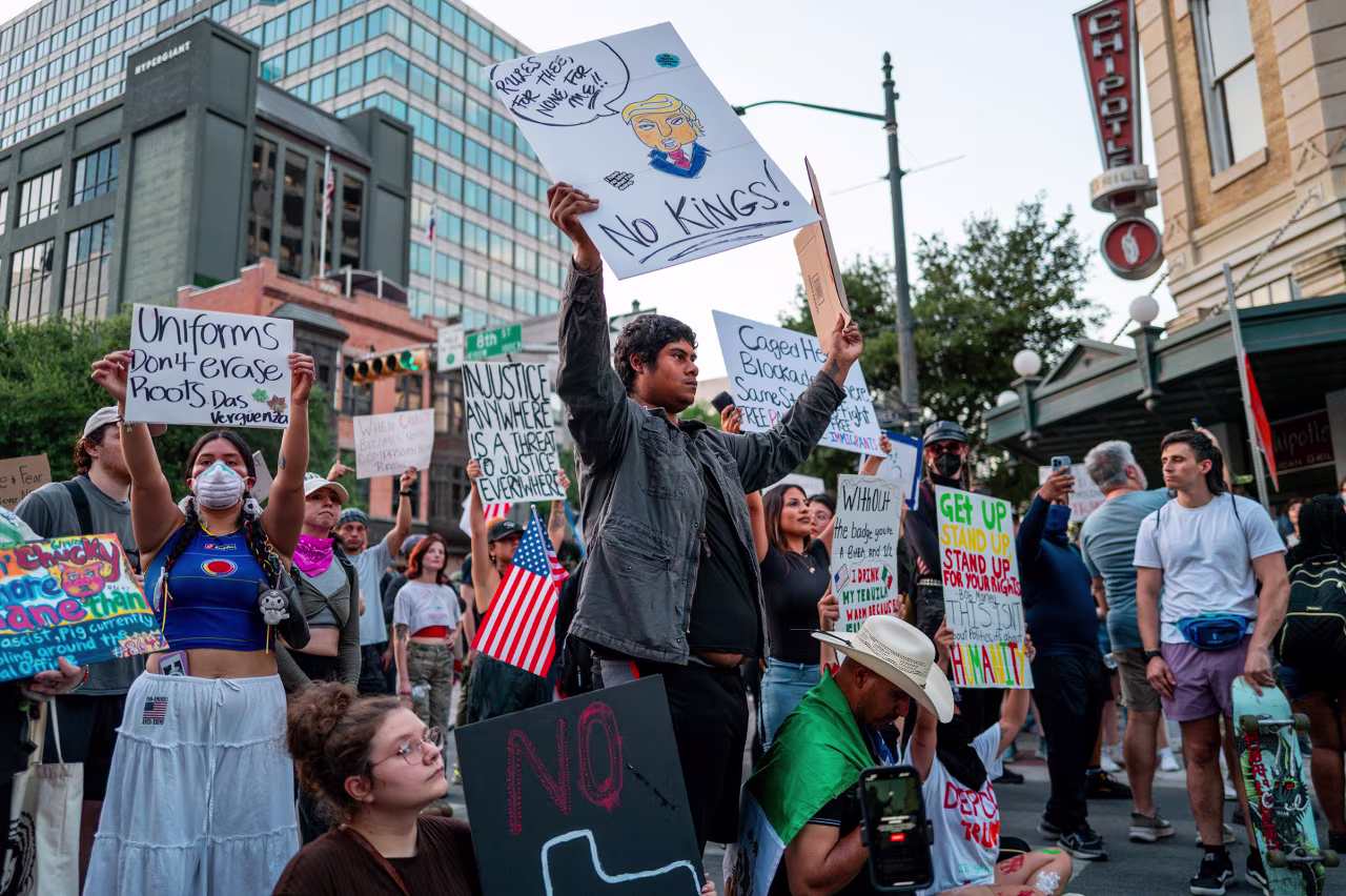 People stand off with law enforcement after marching through downtown Austin, Texas on Saturday, at the conclusion of a "No Kings Day" demonstration.