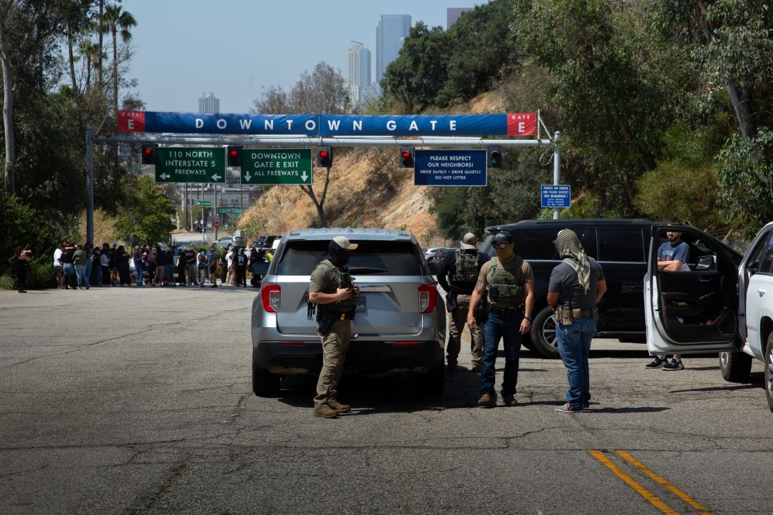 Unidentified agents and their vehicles at Gate E of Dodger Stadium in Los Angeles.