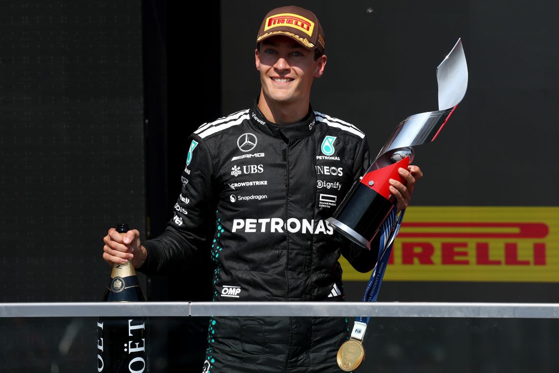 George Russell on the podium with his trophy after winning the Canadian Grand Prix.