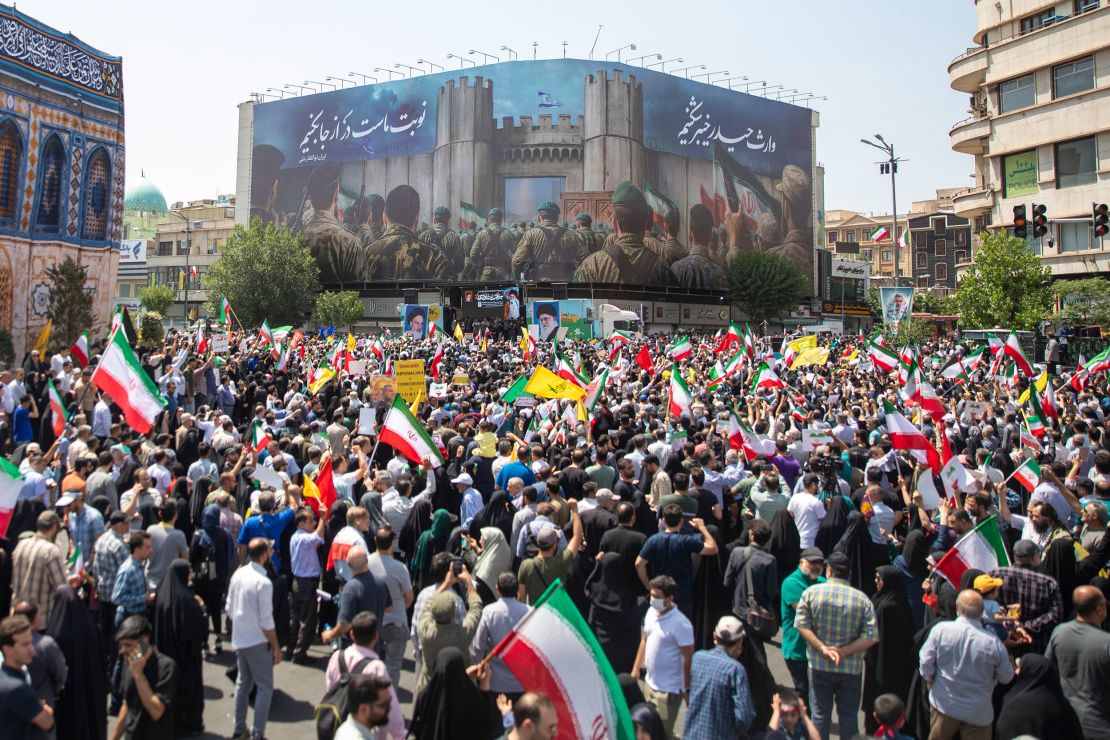 Demonstrators wave Iranian and other flags during a protest against Israeli attacks on Iran, after the Friday prayer ceremonies on June 20, 2025, in central Tehran, Iran.