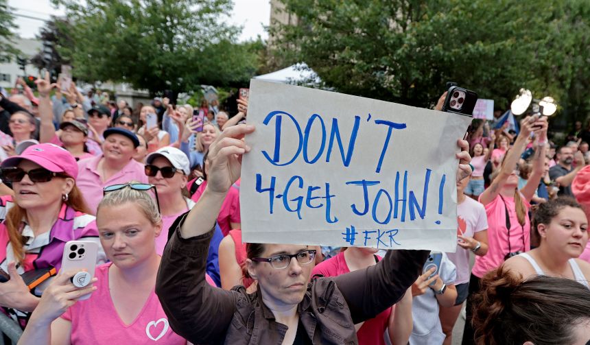 Karen Read supporters cheer for her outside Norfolk Superior Court on June 18, 2025. One sign holder implores people not to forget John O'Keefe after the jury delivered its verdict in her murder retrial.