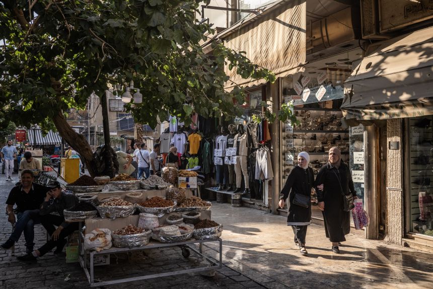 People walking through a shopping street in Damascus, Syria.