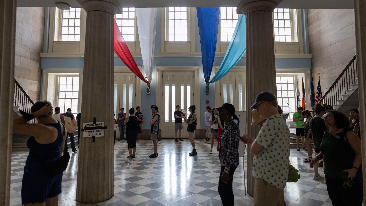 Voters wait in line at a polling station on the last day of early voting for the New York City mayoral Democratic primary in Brooklyn, New York, on June 22.