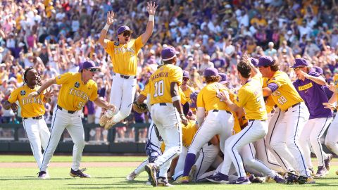 OMAHA, NEBRASKA - JUNE 22: Jake Brown #7 of the LSU Tigers leaps onto the dogpile in celebration after defeating the Coastal Carolina Chanticleers in game two of the Division I Baseball Championship held at Charles Schwab Field on June 22, 2025 in Omaha, Nebraska. (Photo by Tyler McFarland/NCAA Photos via Getty Images)
