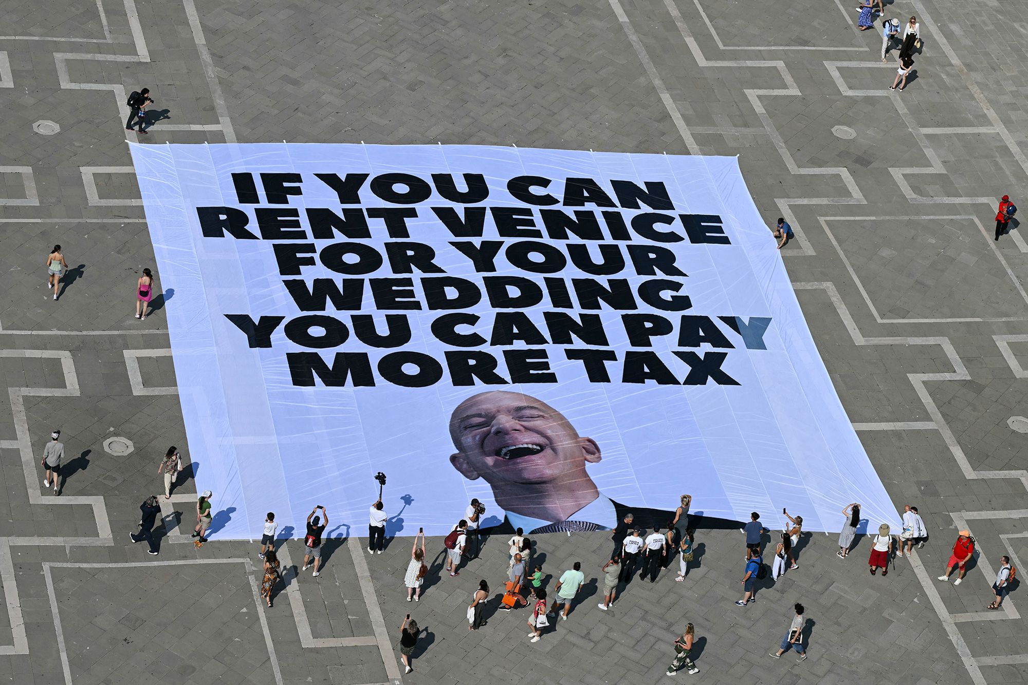 Greenpeace activists unfurled a gigantic banner in Venice days ahead of Jeff Bezos' wedding in the city.