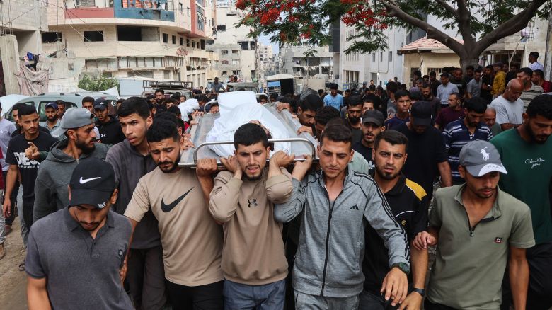 Palestinians carry the body of a man killed a day earlier while attempting to get aid at a distribution point near the Israeli-controlled Zikim border crossing, during a funeral procession at Al-Shifa hospital in Gaza City on June 23, 2025.