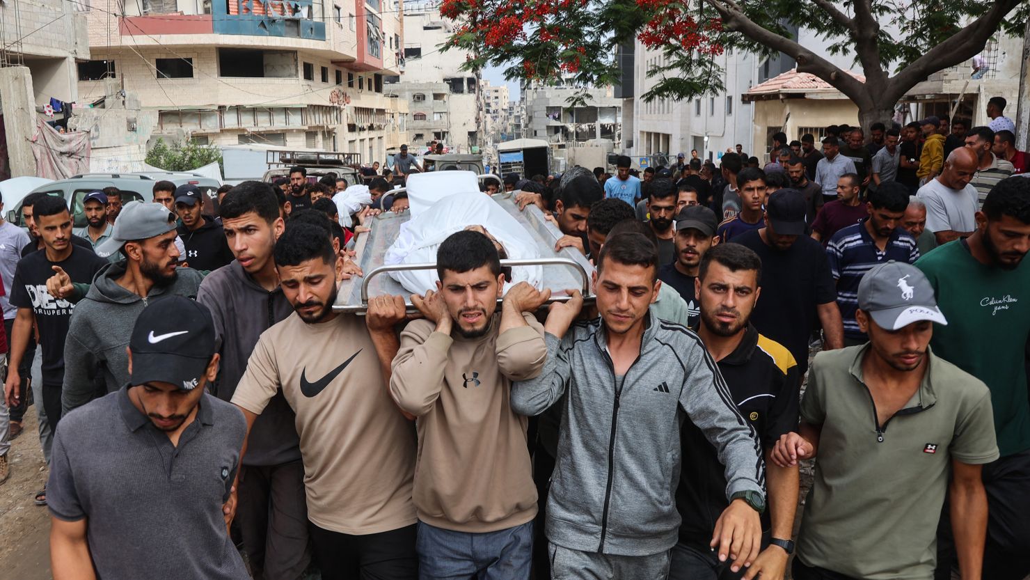 Palestinians carry the body of a man killed a day earlier while attempting to get aid at a distribution point near the Israeli-controlled Zikim border crossing, during a funeral procession at Al-Shifa hospital in Gaza City on June 23, 2025.