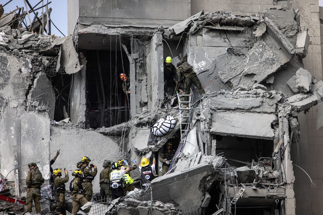 Israeli emergency services and security officers recover a body from the rubble of a building hit by an Iranian missile in Beer Sheva in southern Israel on Tuesday.