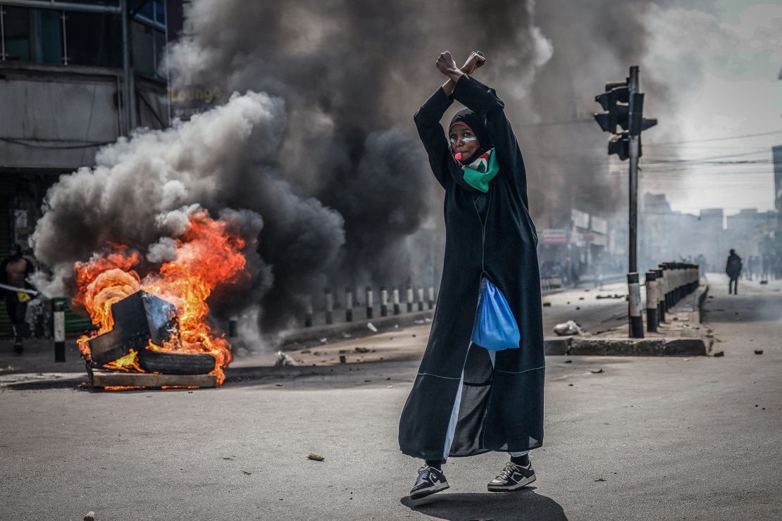 A protester reacts in front of a burning barricade in downtown Nairobi on Wednesday.