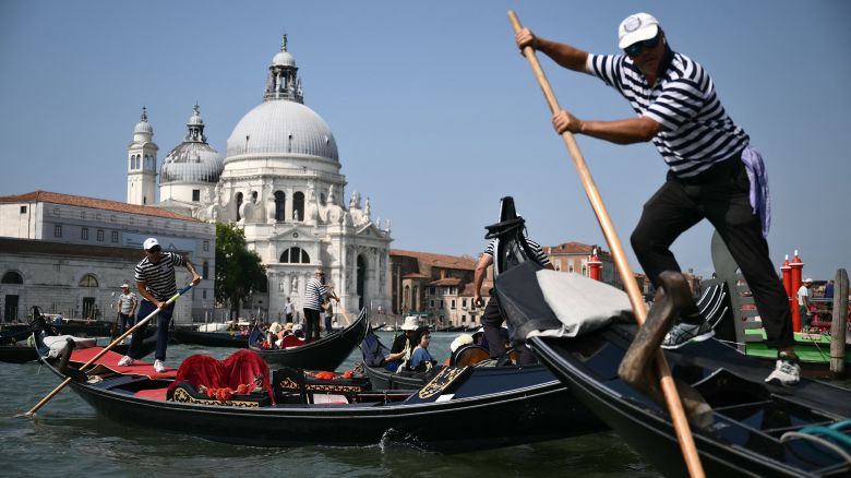 Tourists enjoy a gondola ride on the Grand Canal in Venice lagoon on June 25, 2025. Celebrities in superyachts sail into Venice this week for the three-day wedding party of Amazon tycoon Jeff Bezos and Lauren Sanchez, despite irate locals who say the UNESCO city is no billionaire's playground. The tech magnate and journalist have reportedly invited about 200 guests to their multi-million dollar nuptials in the Italian city, which are expected to kick off on June 26 and end Saturday with a ceremony at a secret location.