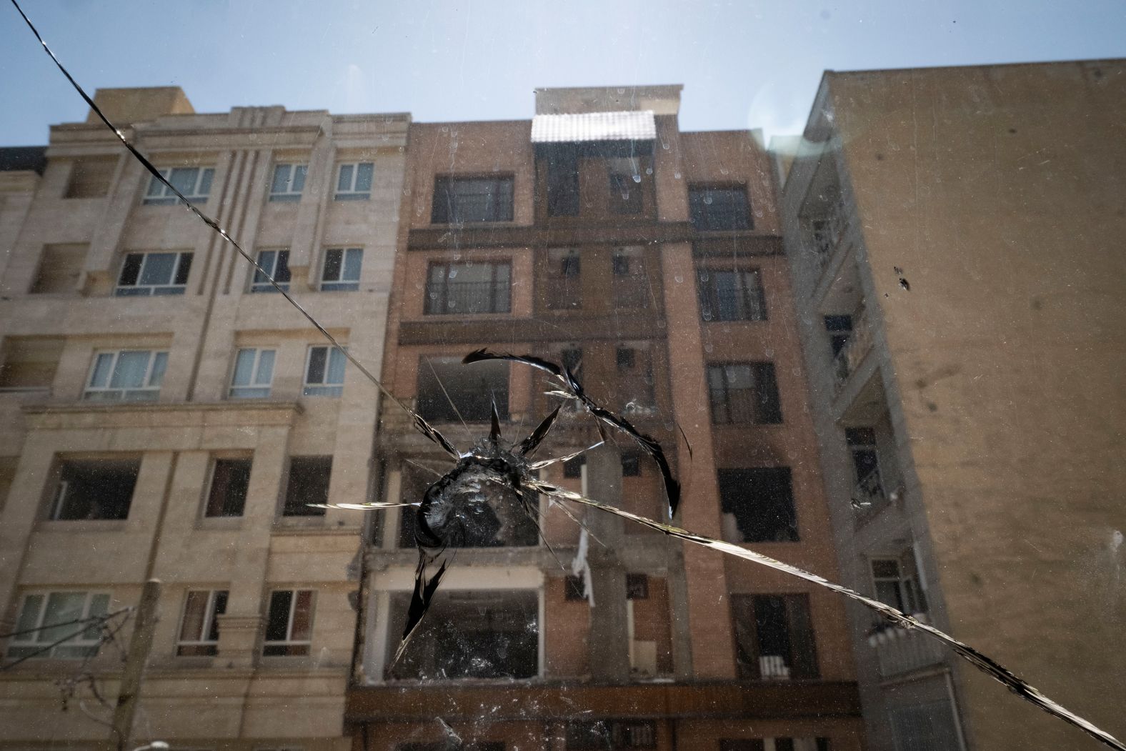 A window is broken in front of a building in Tehran on Wednesday.