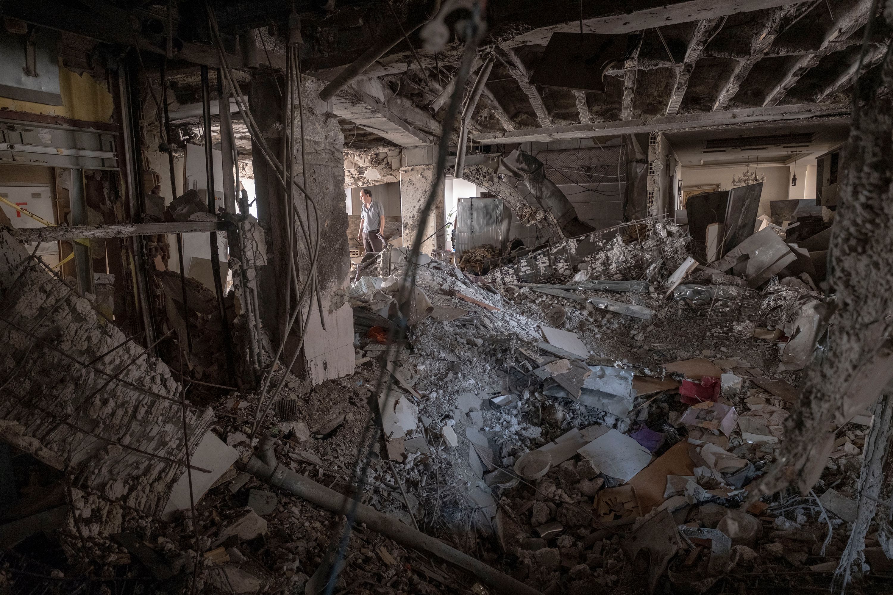 A man stands in what's left of an apartment in Tehran, Iran, on Wednesday, June 25. It was destroyed in an Israeli attack.