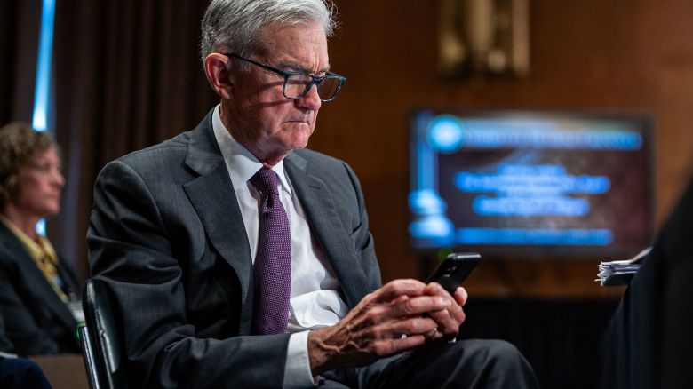 Federal Reserve Chair Jerome Powell looks at a phone during a Senate Banking, Housing, and Urban Affairs Committee hearing in Washington, DC, on June 25, 2025.