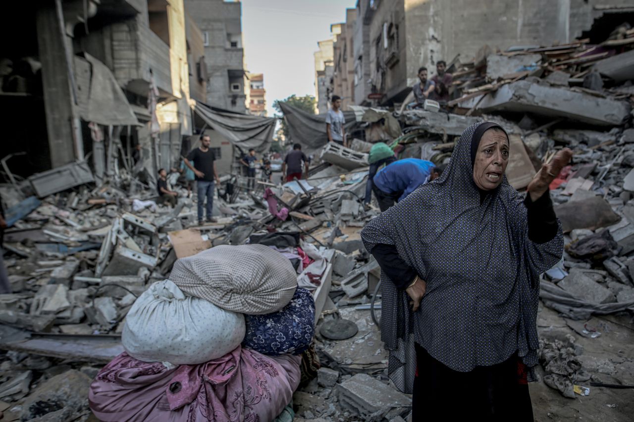 Palestinians search for usable items in the rubble of heavily damaged and collapsed buildings after Israeli attacks on Al-Shati refugee camp on Thursday.