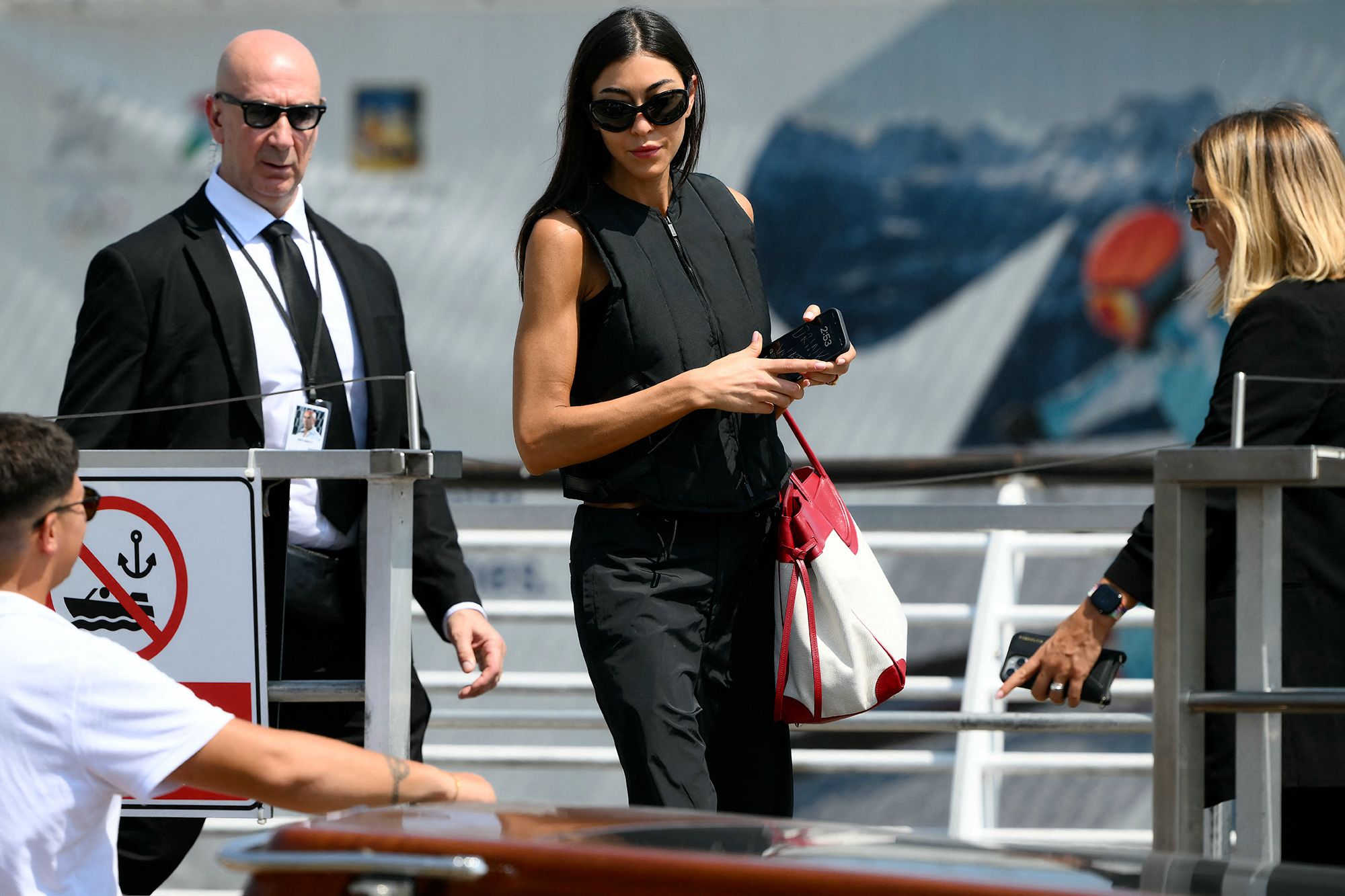 Fashion designer Sarah Staudinger boards a taxi boat after landing in Venice on Thursday.