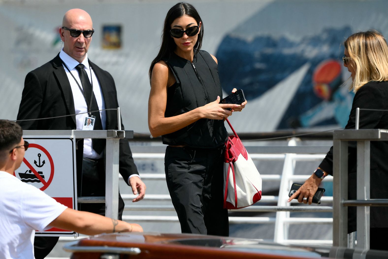Fashion designer Sarah Staudinger boards a taxi boat after landing in Venice on Thursday.