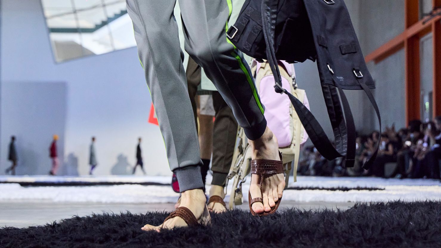 Models walking the Prada runway during Milan's Men's Fashion Week in June 2025. Many observers were quick to identify the resemblance of the brand's sandals to traditional footwear from India.