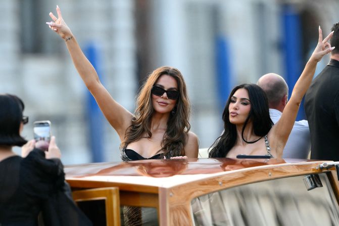Kris Jenner takes a photo of Khloe and Kim Kardashian on a taxi boat on Thursday.