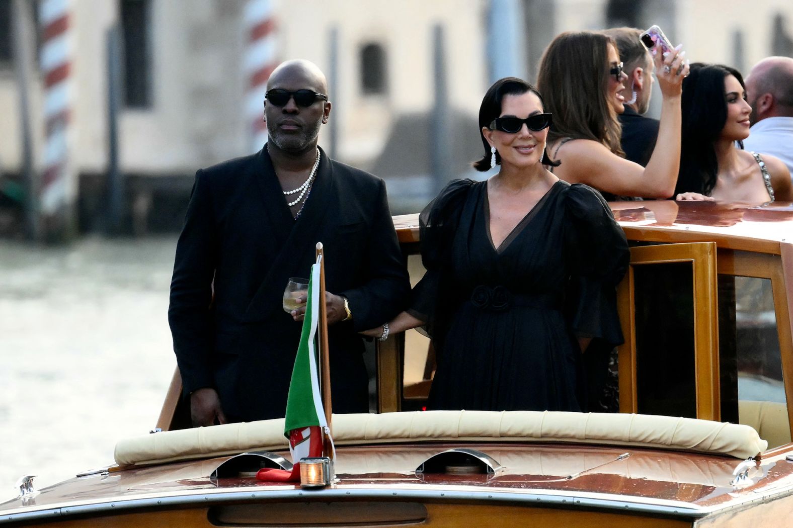 Corey Gamble and Kris Jenner ride a taxi boat as they leave the Gritti Palace hotel on Thursday.