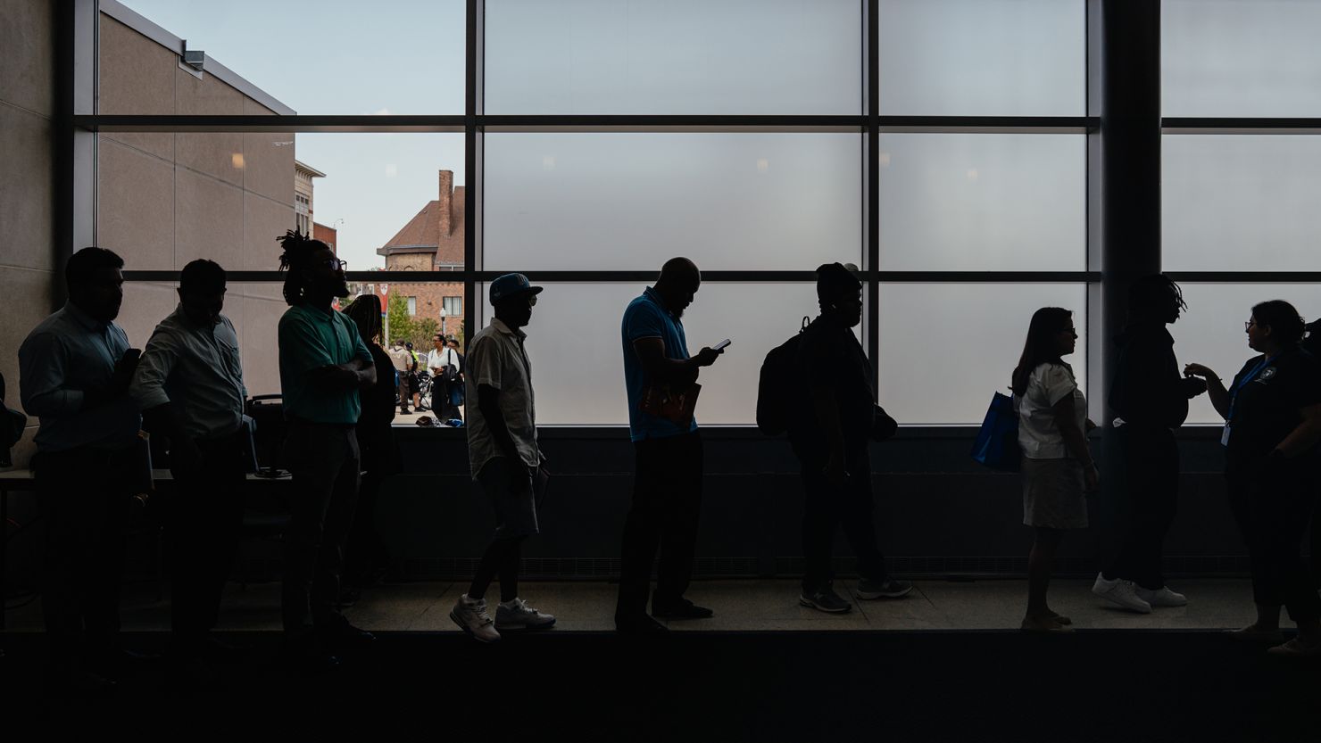 Businesses highly uncertain about the direction of the economy in the wake of massive (and changing) tariffs proposed by President Donald Trump have held off on hiring, causing once-solid job gains to slow. Other policies, including federal workforce cuts, have turned public servants into jobseekers such as those seen here waiting to enter a job fair hosted by the Cook County government to support federal workers in Chicago on June 26, 2025.