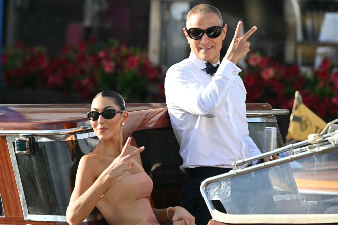 Fashion designer Sarah Staudinger and talent agent Ari Emanuel pose for photos on their way to the wedding on Friday.