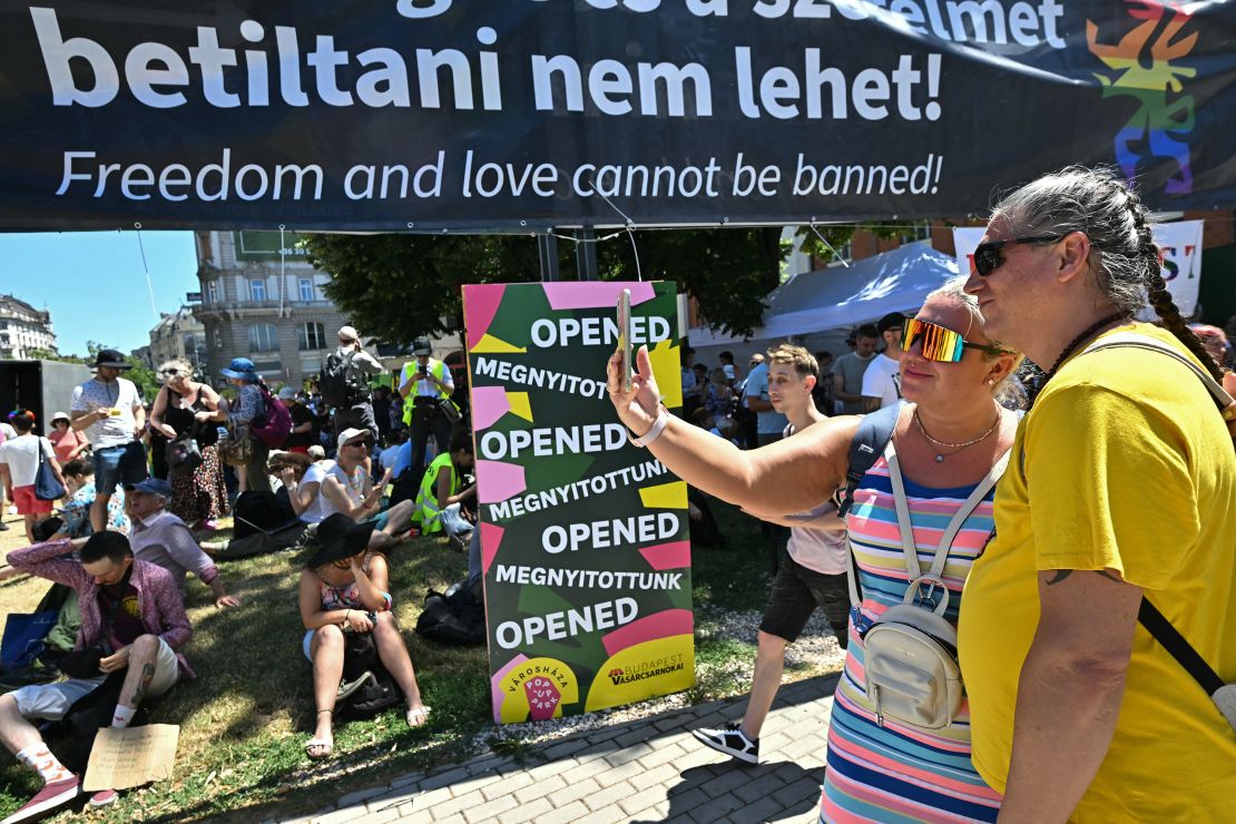 Participants pose for a selfie as they arrive to take part in the event despite a government ban.