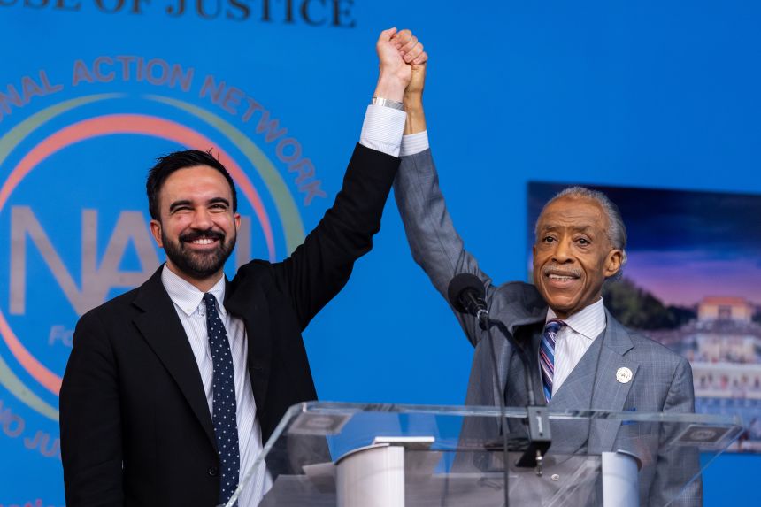 Mamdani, left, raises hands with Rev. Al Sharpton, founder and president of the National Action Network, during a campaign event at the NAN House of Justice in the Harlem neighborhood of New York on Saturday, June 28, 2025.