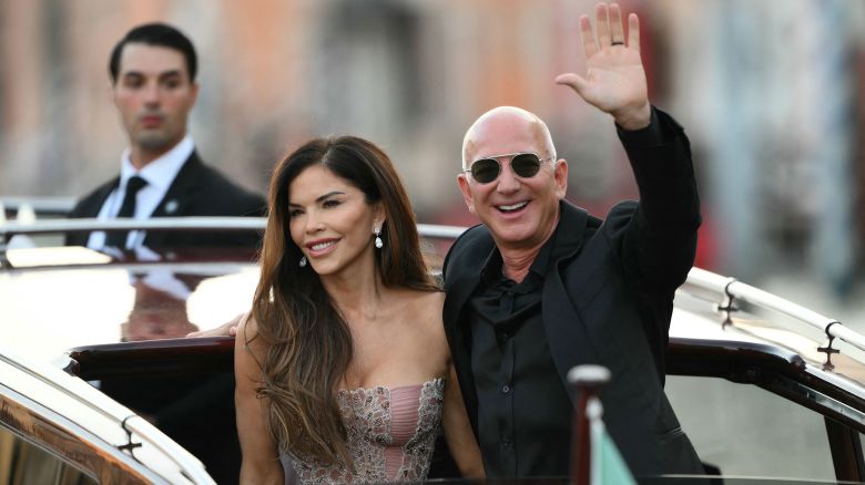 Amazon's founder Jeff Bezos and spouse Lauren Sanchez Bezos leave the Aman Hotel on the third day of their wedding festivities, in Venice on June 28, 2025.  (Photo by Marco BERTORELLO / AFP) (Photo by MARCO BERTORELLO/AFP via Getty Images)          