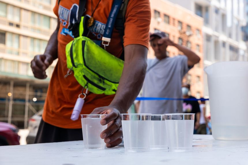 The Salvation Army distributes water in New York City as people try to stay cool on Wednesday, June 25.