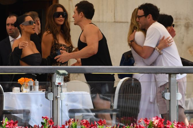 From left, Kim Kardashian, Khloe Kardashian and Orlando Bloom are seen in Venice on Thursday. Khloe was dressed in a Skims x Dolce & Gabbana catsuit.