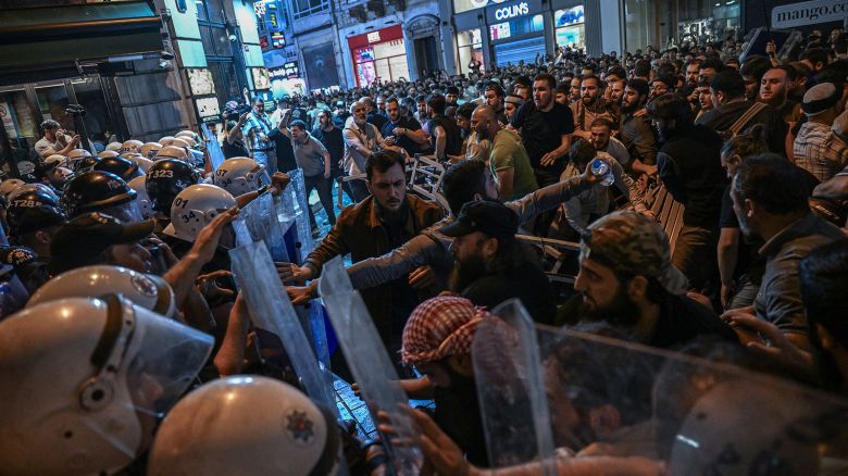 Islamist protesters clash with Turkish anti riot police officers as they gather to protest Leman cartoon magazine in Istanbul on June 30, 2025.