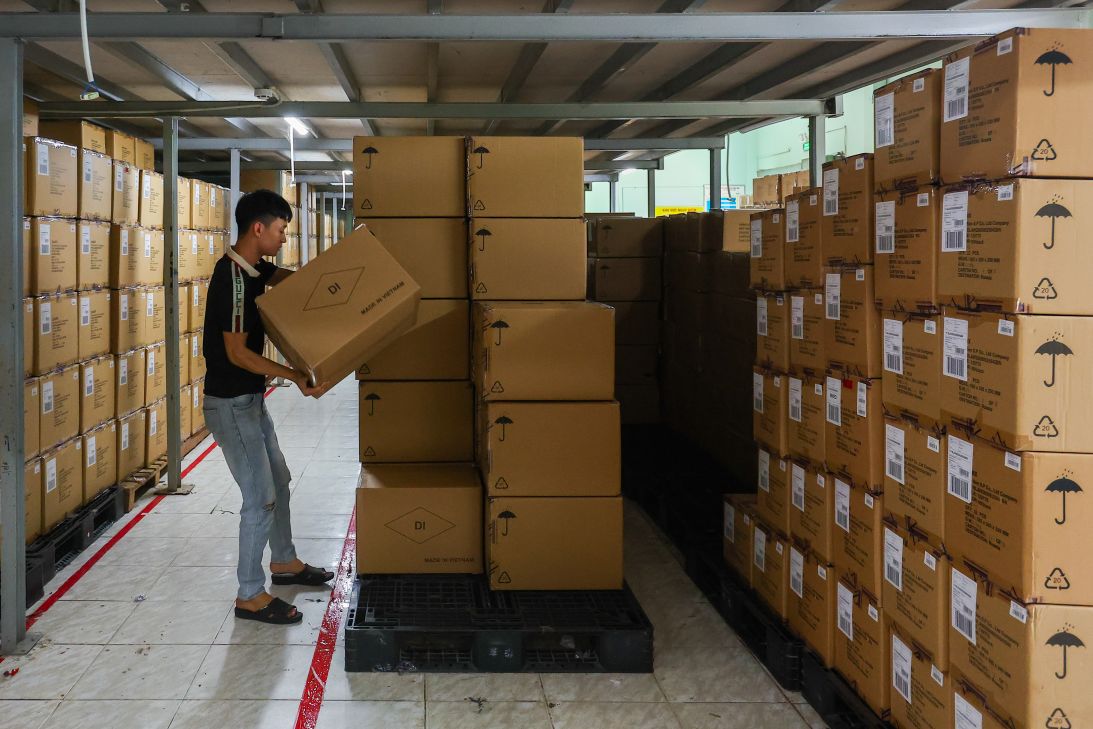A worker moves a parcel inside a warehouse at a garment factory in Ho Chi Minh, Vietnam on June 21, 2025.