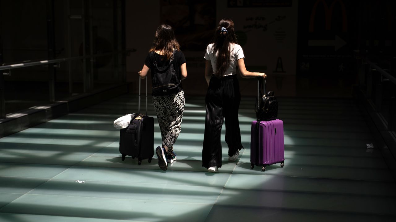 Two women with suitcases at Adolfo Suarez Madrid-Barajas airport during the first departure operation of summer 2025, on 27 June, 2025 in Madrid, Spain. Aena estimates that airlines have scheduled almost 1.4 million landing and takeoff operations at Spanish airports during the entire summer 2025 season (March 30 to October 25), an increase of 1.2% over 2024.