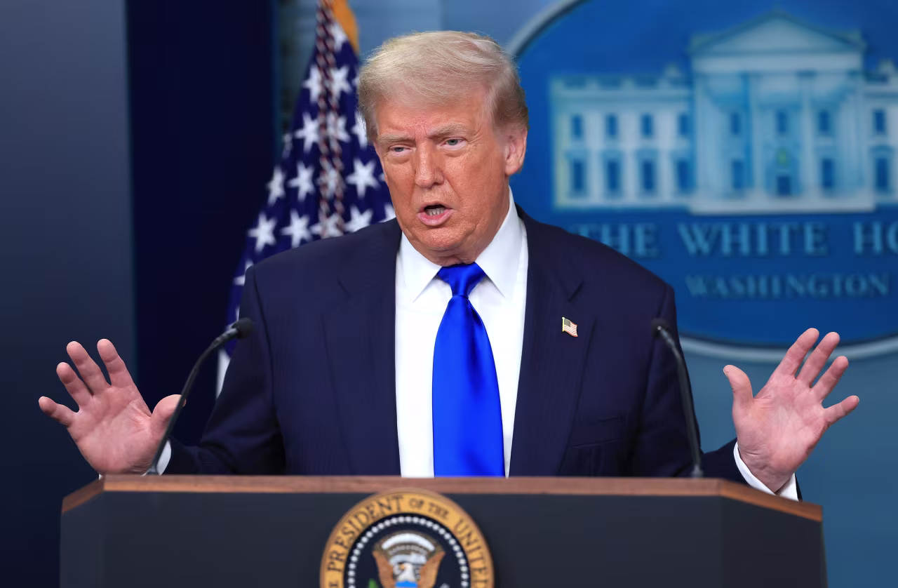 President Donald Trump answers questions at the White House on Friday.